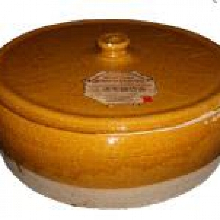 A CLAY CASSEROLE DISH WITH LID